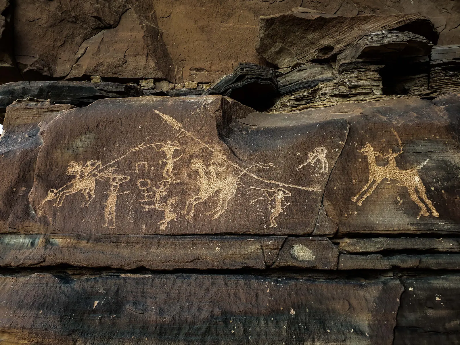 A rock panel of horses and riders, carved in stone